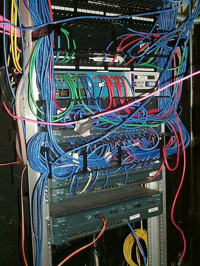 A network equipment rack with different cable routes and interfaces.