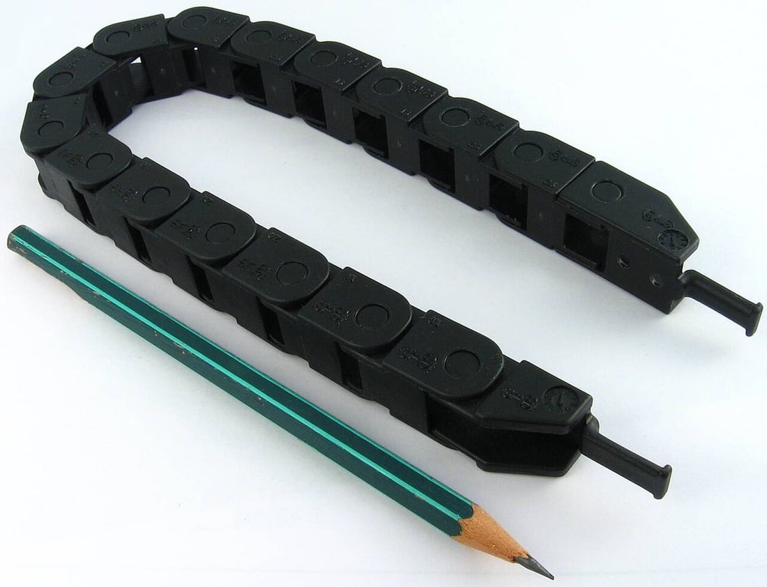 A cable carrier guides repeated movement; bend radius and cable construction remain separate checks.