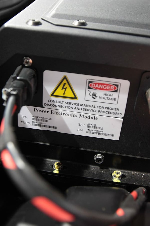 Battery-pack warning labels highlight the need for defined high-voltage handling and validation.