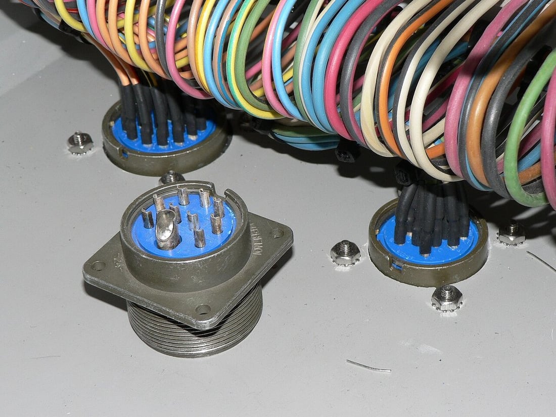 Amphenol circular connectors before and after wire termination.