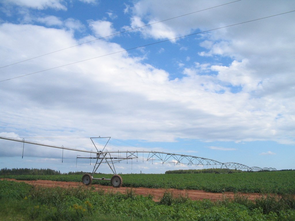 Field irrigation equipment illustrates exposed outdoor machinery and distributed control points.