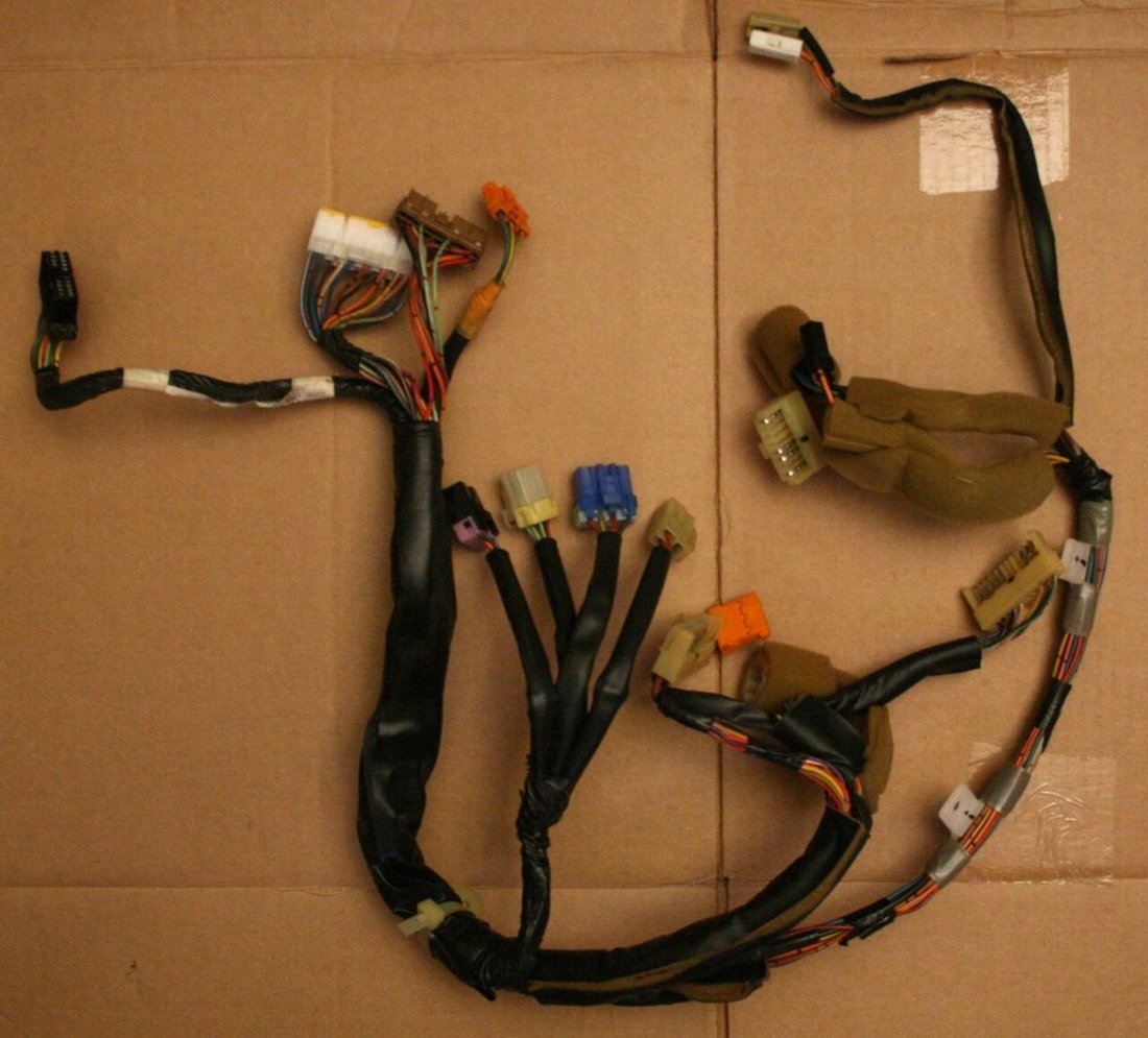 A vehicle instrument-cluster harness illustrates branch and connector diversity; not an Aptiv part identification.