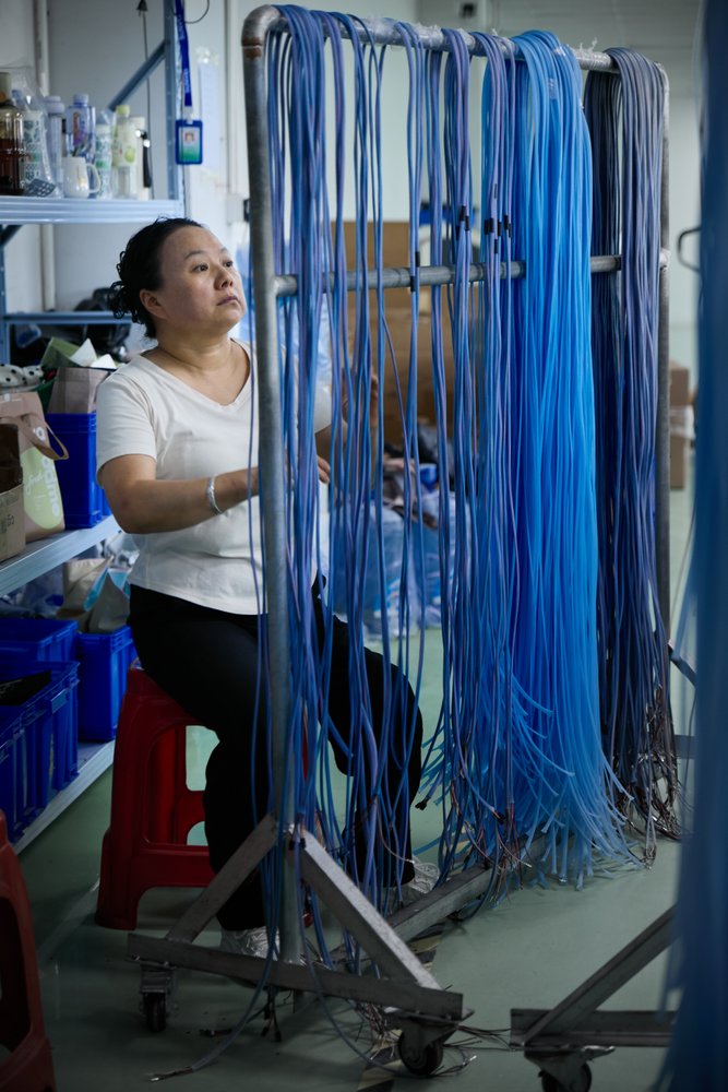 Super Smile wire-handling area; material readiness is checked against the approved BOM.