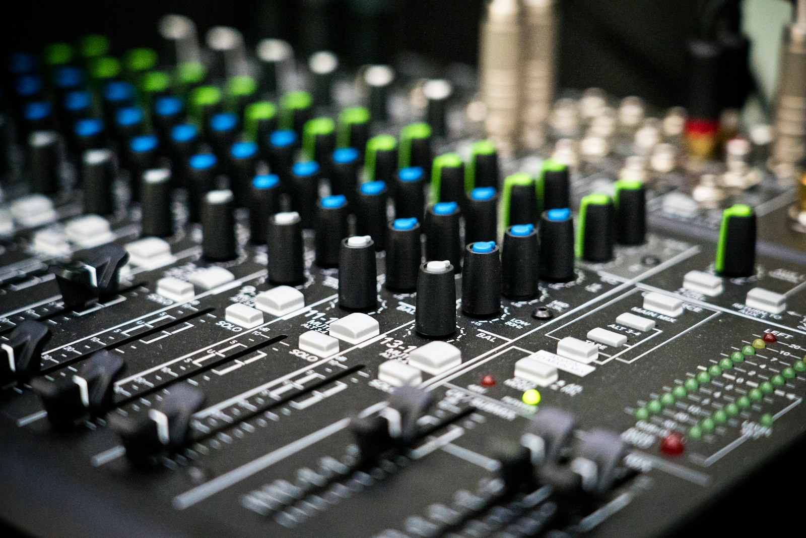 Faders and control knobs on an audio mixing console