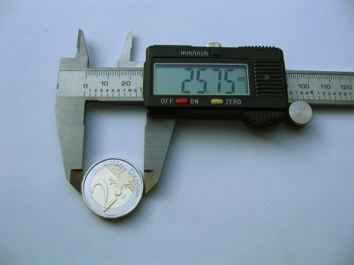 A caliper illustrates dimensional measurement; cable drawings still need defined terminal datums.