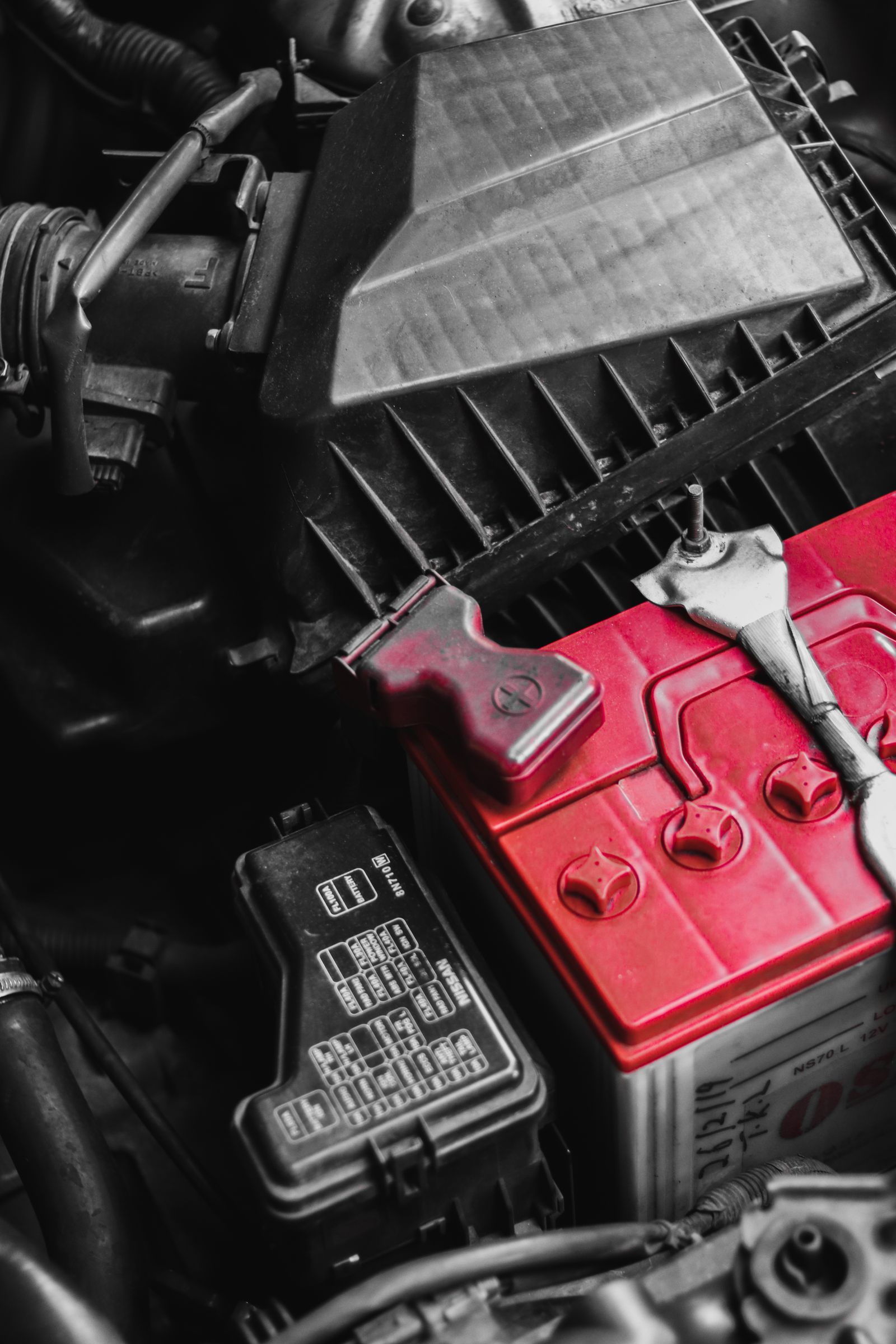 Battery installed in a vehicle engine compartment