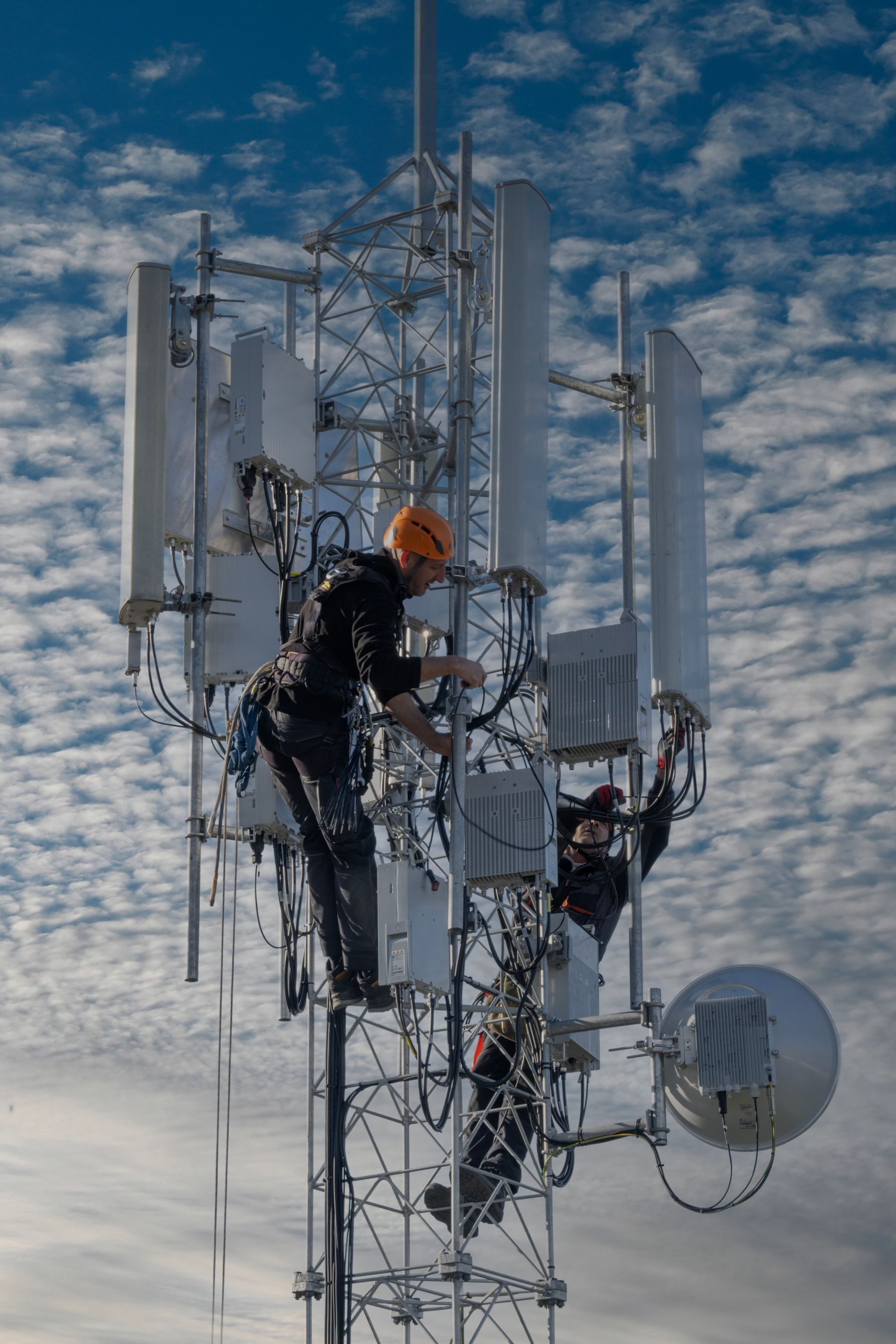 Telecommunications technicians working on an antenna tower