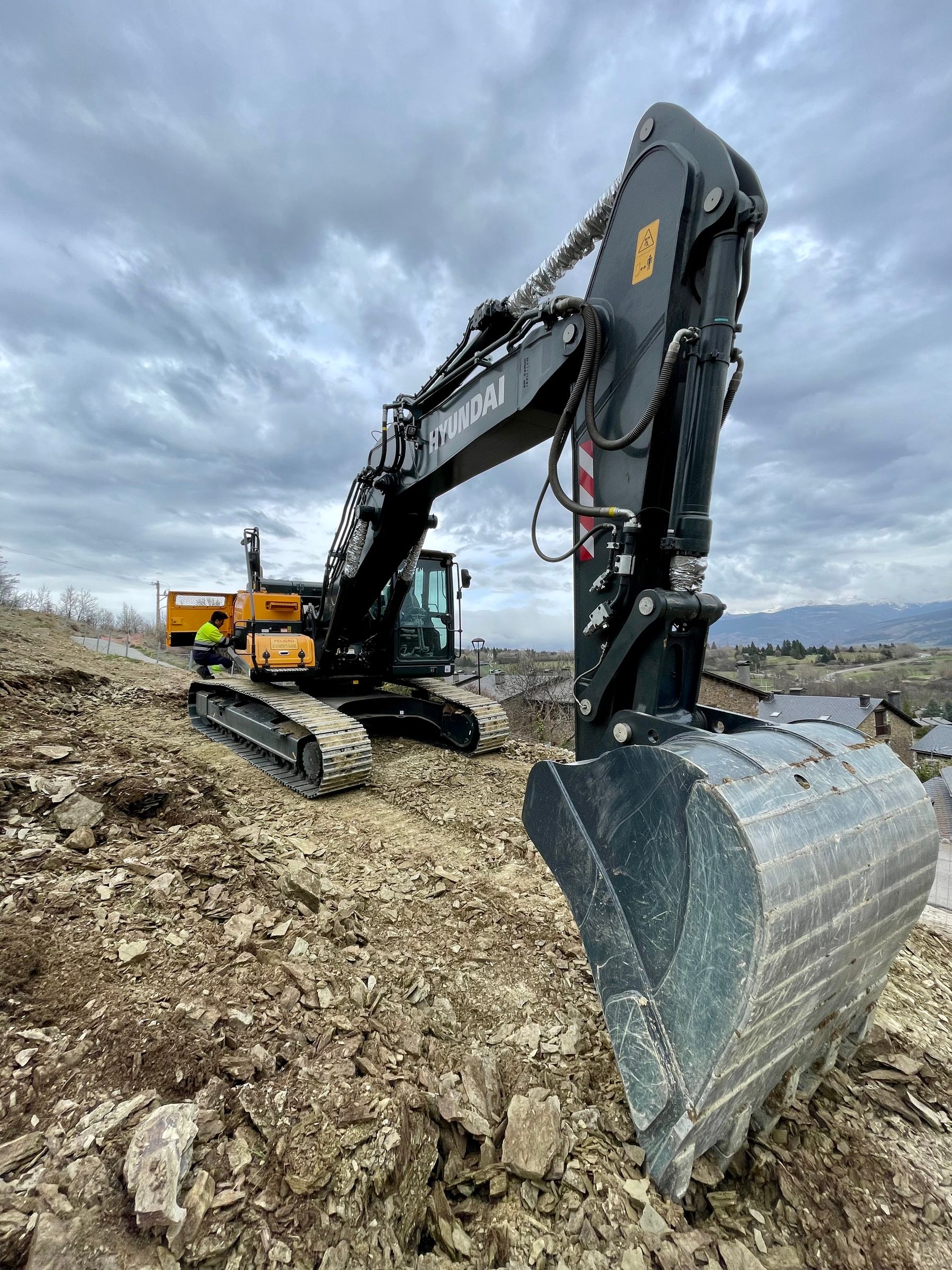 Construction vehicle harness routing on an excavator boom