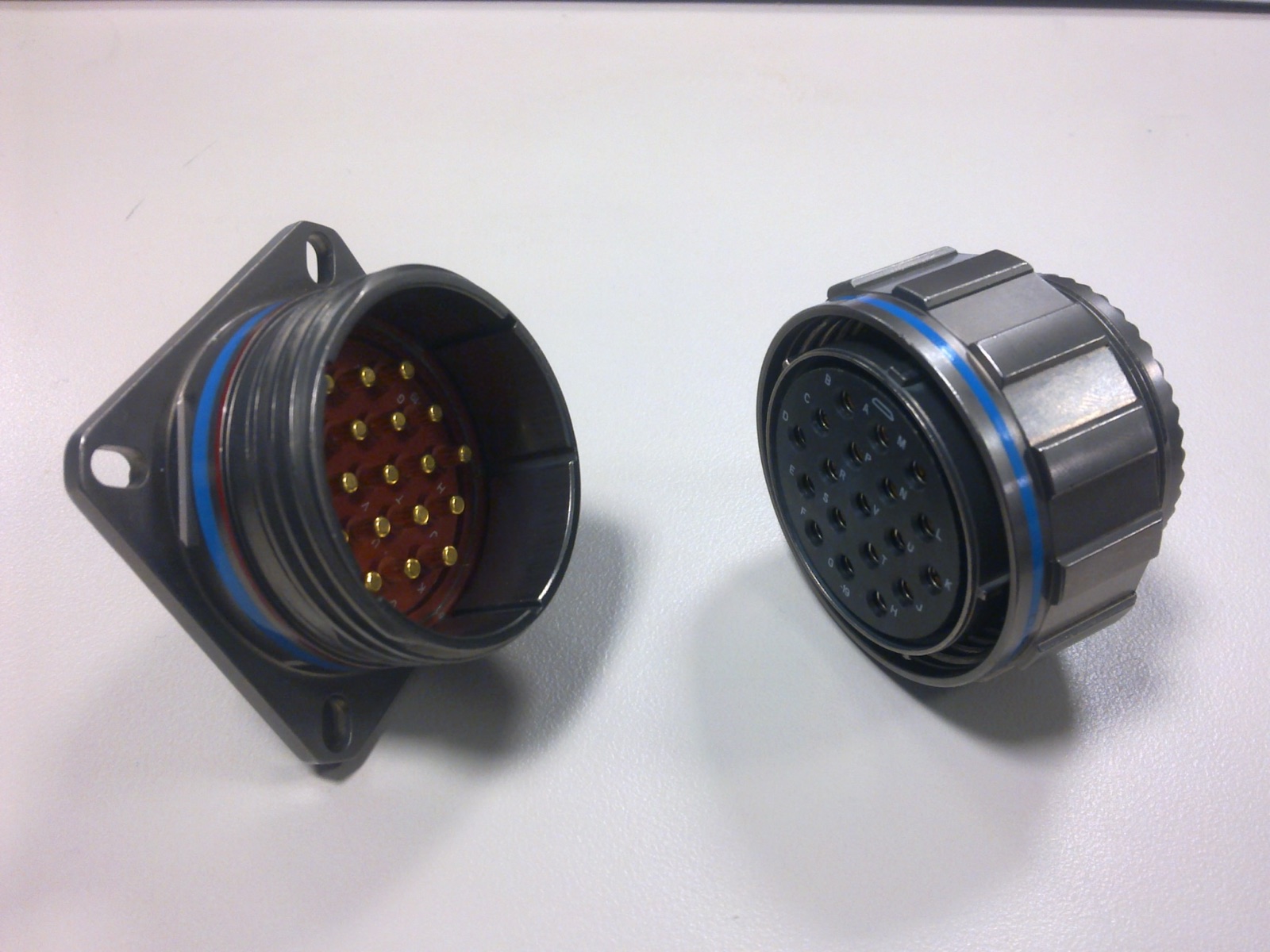 Two third-party metal circular connector halves on a light background
