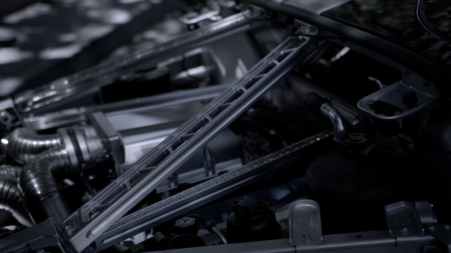 Fuse enclosure and adjacent cables in an engine bay