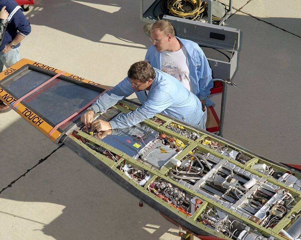 NASA technicians working on a research vehicle illustrate controlled aerospace assembly, not our qualification or supply record.