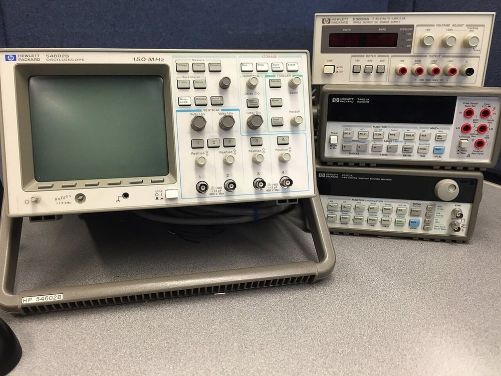 A bench oscilloscope and instruments illustrate electrical evaluation, not a measured result for this harness.