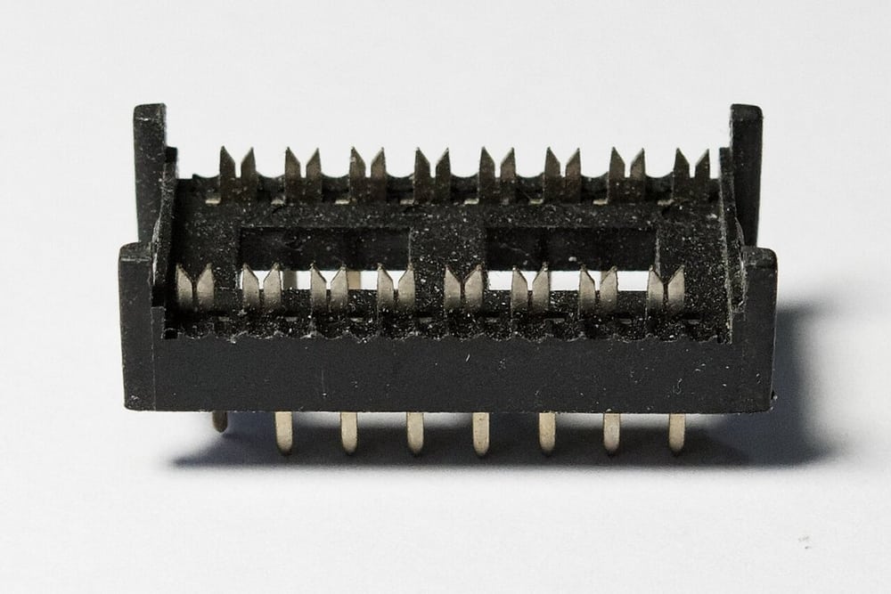 Exposed IDC contacts illustrate why housing and contact features need inspection; this is not a loose-pin failure sample.