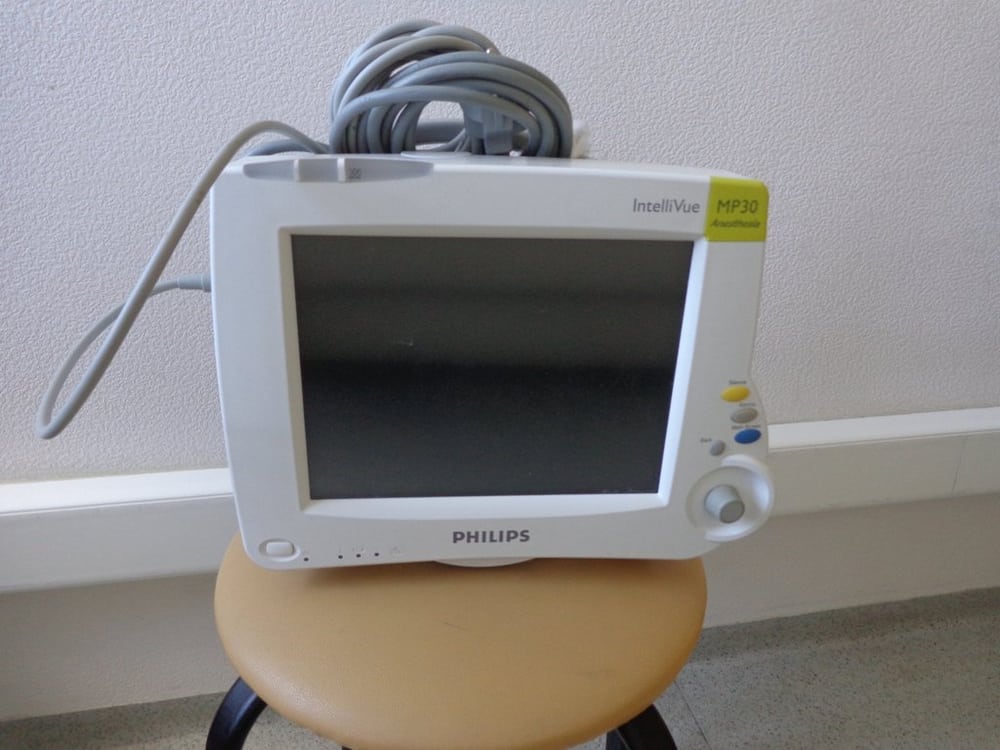 A medical monitor provides equipment context; no medical approval or supply relationship is implied.