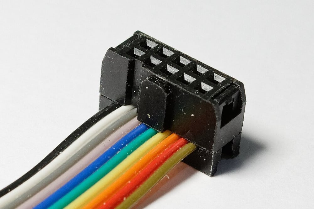 IDC termination on a ribbon cable illustrates conductor alignment.