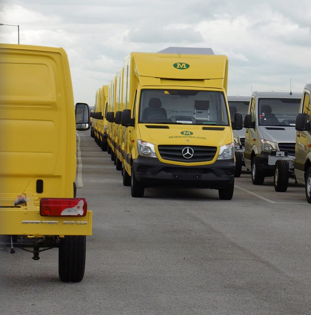 Delivery vehicles illustrate repeated fleet installations across several units.
