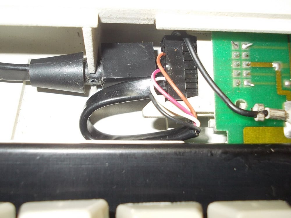 Cable routing and retention inside a keyboard illustrate enclosure-level fit checks.