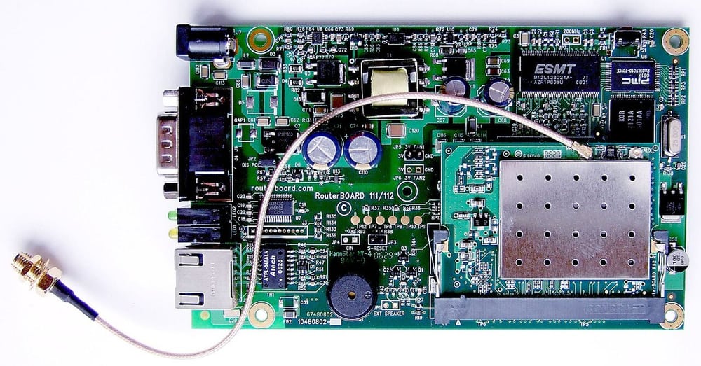 Router board with antenna pigtails shows the RF path between board and enclosure.