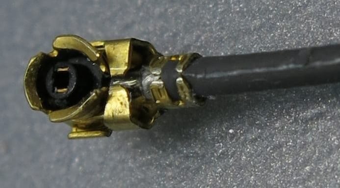 U.FL cable plug close-up; identify the complete mating interface before assembly.