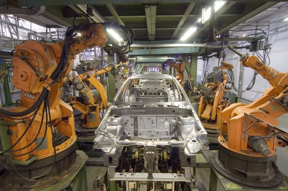 Industrial robot cells illustrate repeated motion and the need to separate moving and fixed routes.