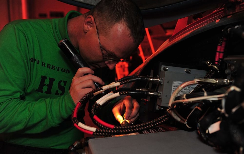 Technician identifying connector wiring; application reference, not Super Smile staff or a Hirose claim.