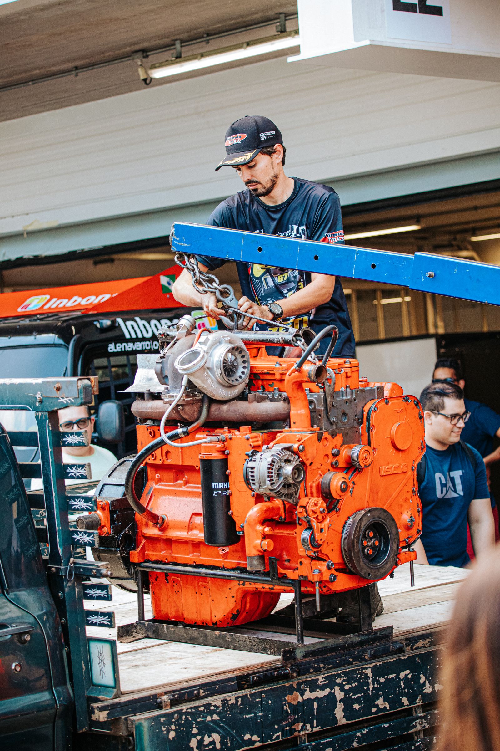 Technicians servicing a large engine in a workshop