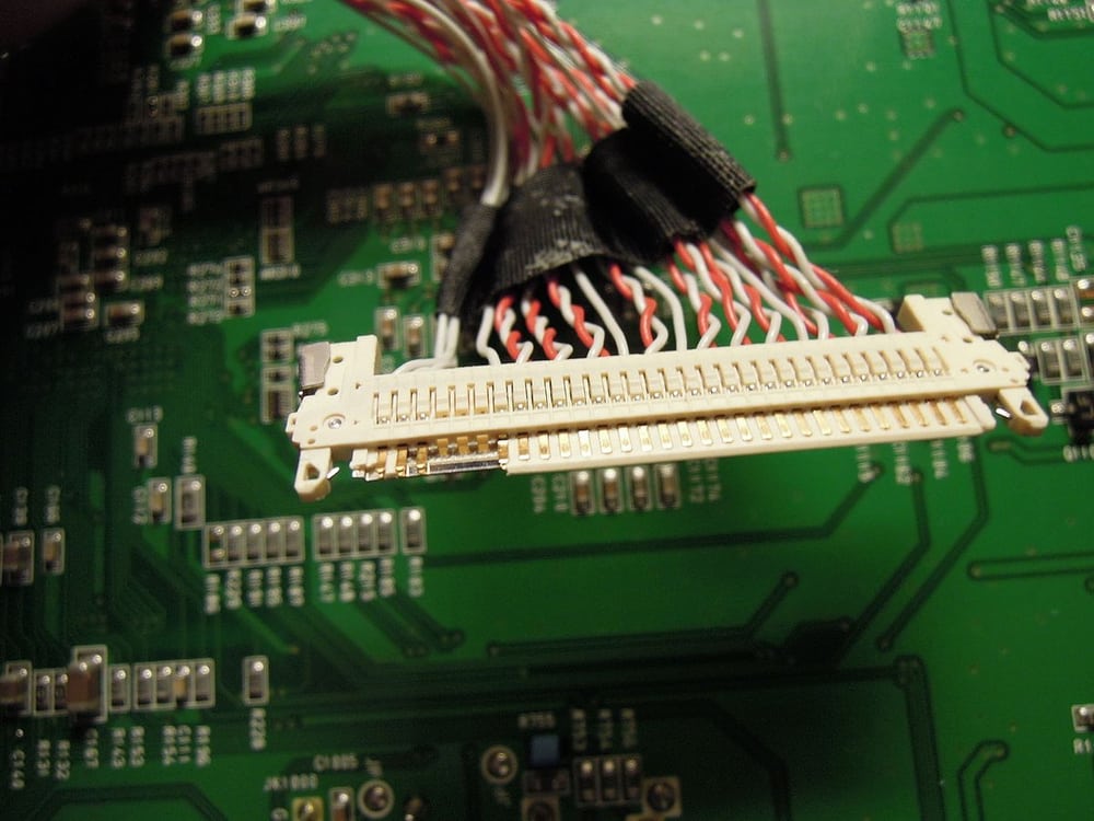 A monitor's board-to-panel harness provides display-wiring context; its series is not identified here.