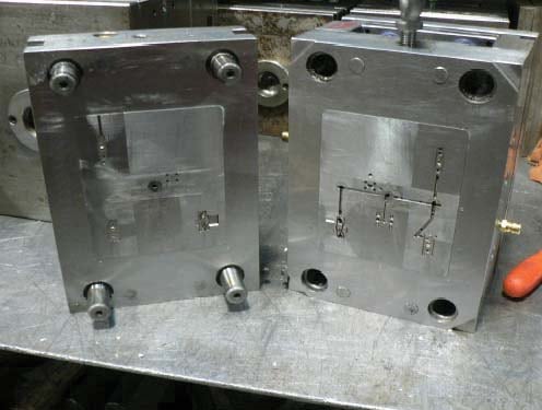 An injection mould illustrates how small plastic features depend on tooling and process control.