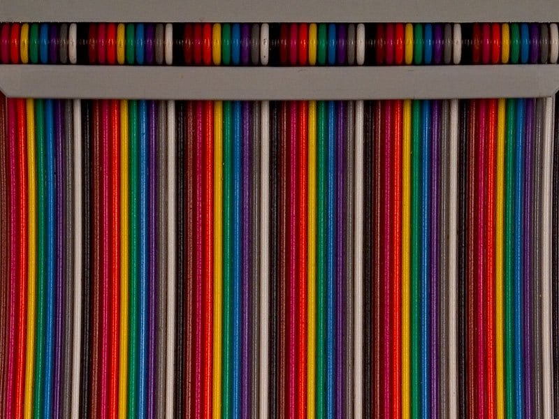 Color-coded ribbon conductors help illustrate circuit identification; colors alone do not define a pinout.