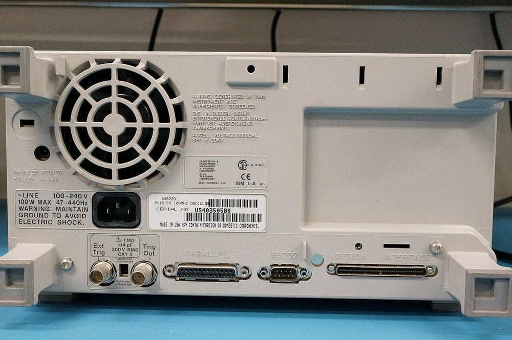 An instrument rear panel shows why equipment identity and specified conditions matter in verification.