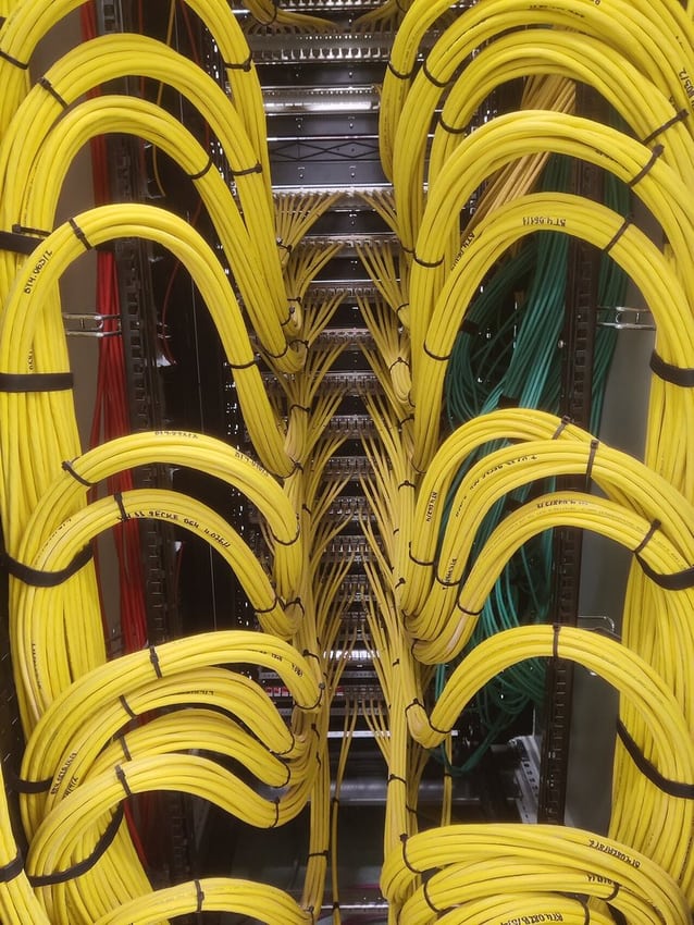 Organized patch-panel wiring illustrates identification and service access.