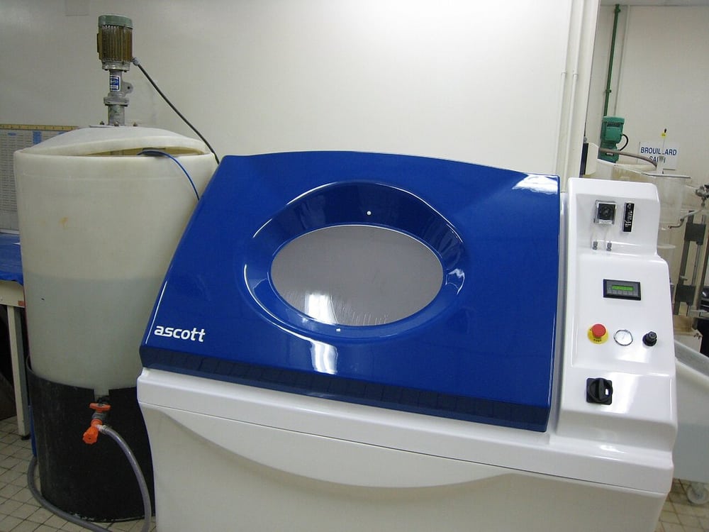 A salt-spray chamber illustrates a defined laboratory exposure method.