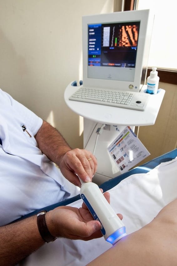 An instrument and handheld probe during a diagnostic examination.