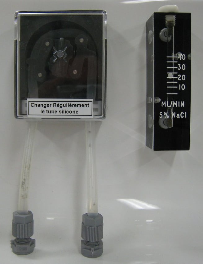 Instrument-mounted pump and tubing illustrate an equipment-module environment.