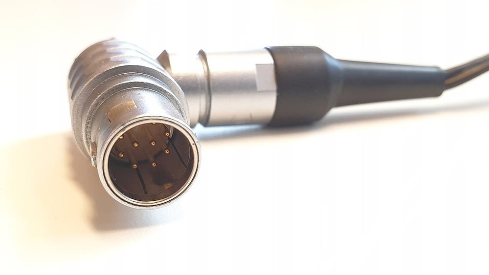A photographed ten-contact LEMO plug with its cable exit.