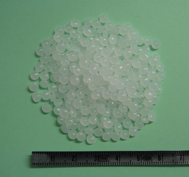 LLDPE resin granules illustrate polymer selection; they are not identified as REDEL housing material.