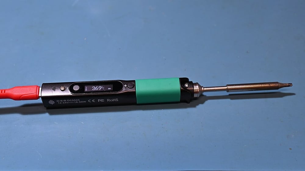 A soldering tool illustrates controlled electrical termination work.