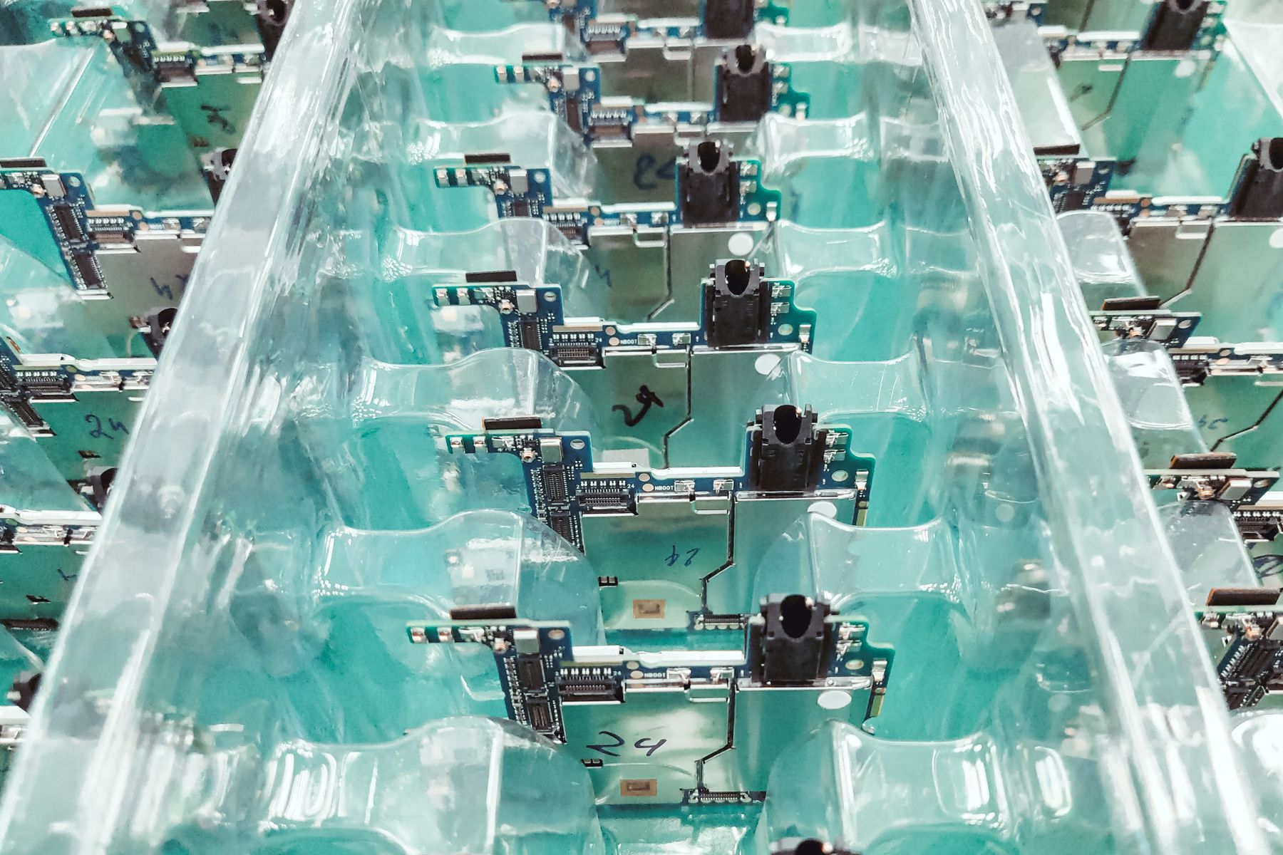 Printed circuit boards arranged before protective encapsulation