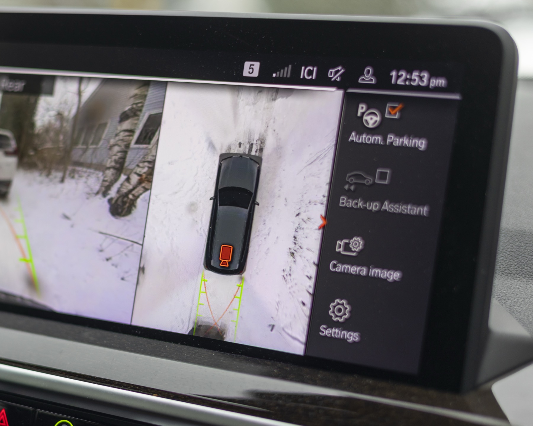 Vehicle display showing parking-camera and overhead views