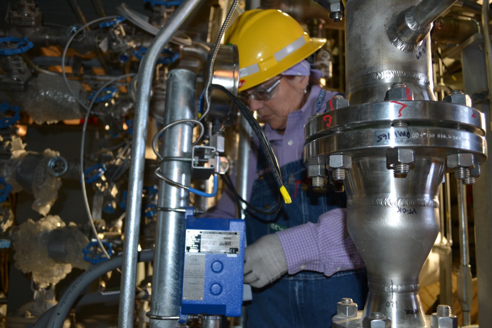 Electrician working at a magnetic flow transmitter terminal