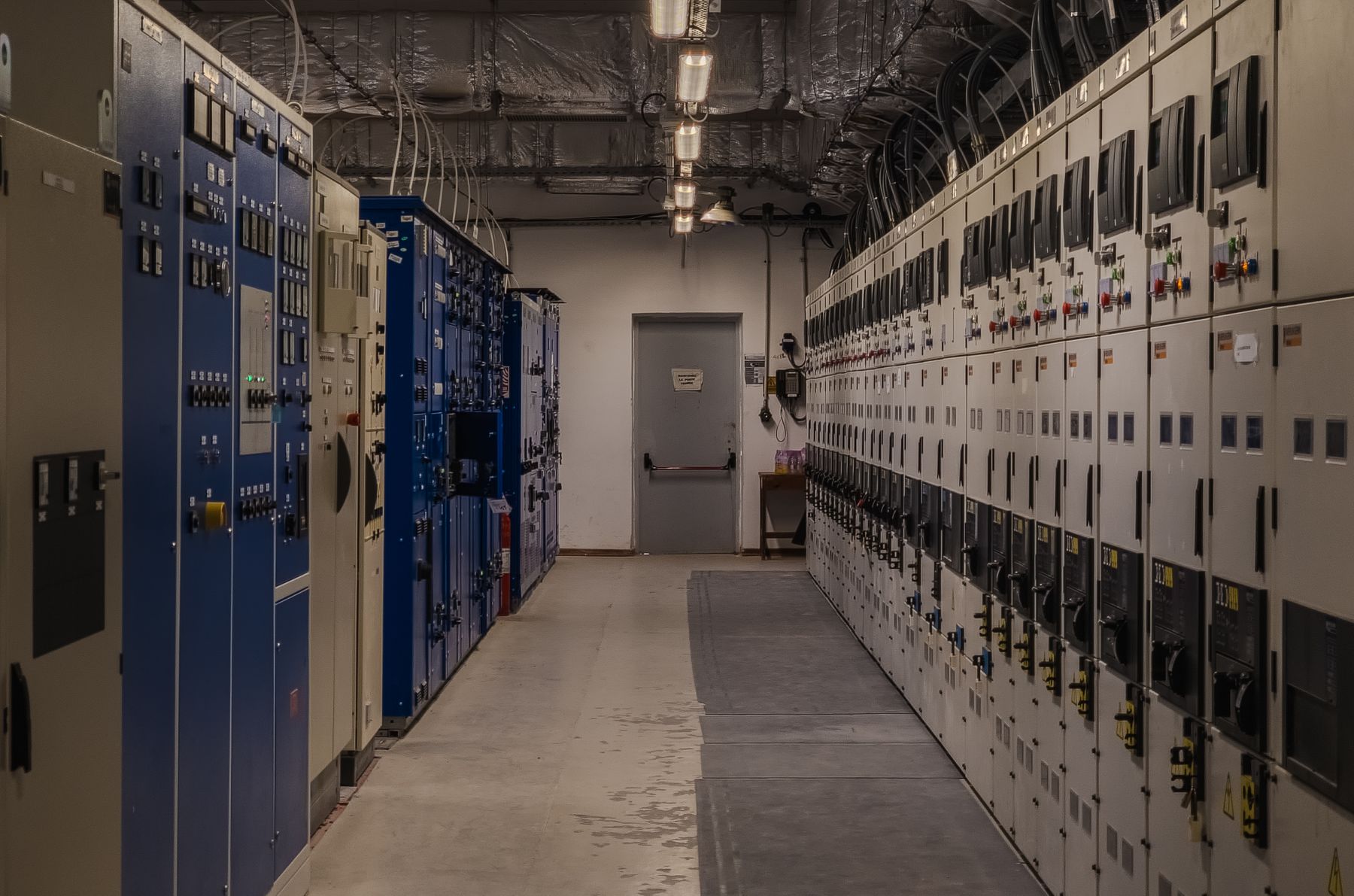 Industrial aisle lined with electrical control cabinets