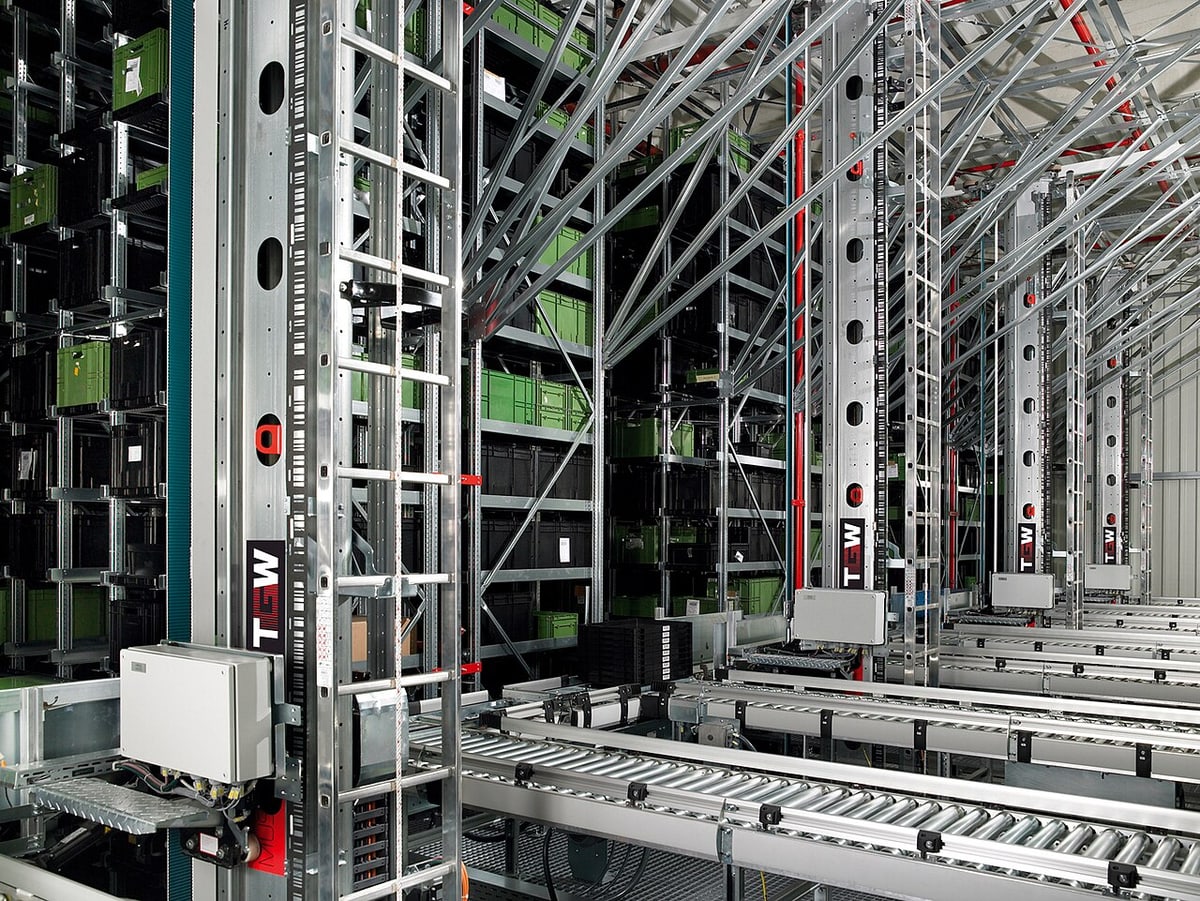 Automated small-parts storage illustrates material availability and picking, not Super Smile inventory.