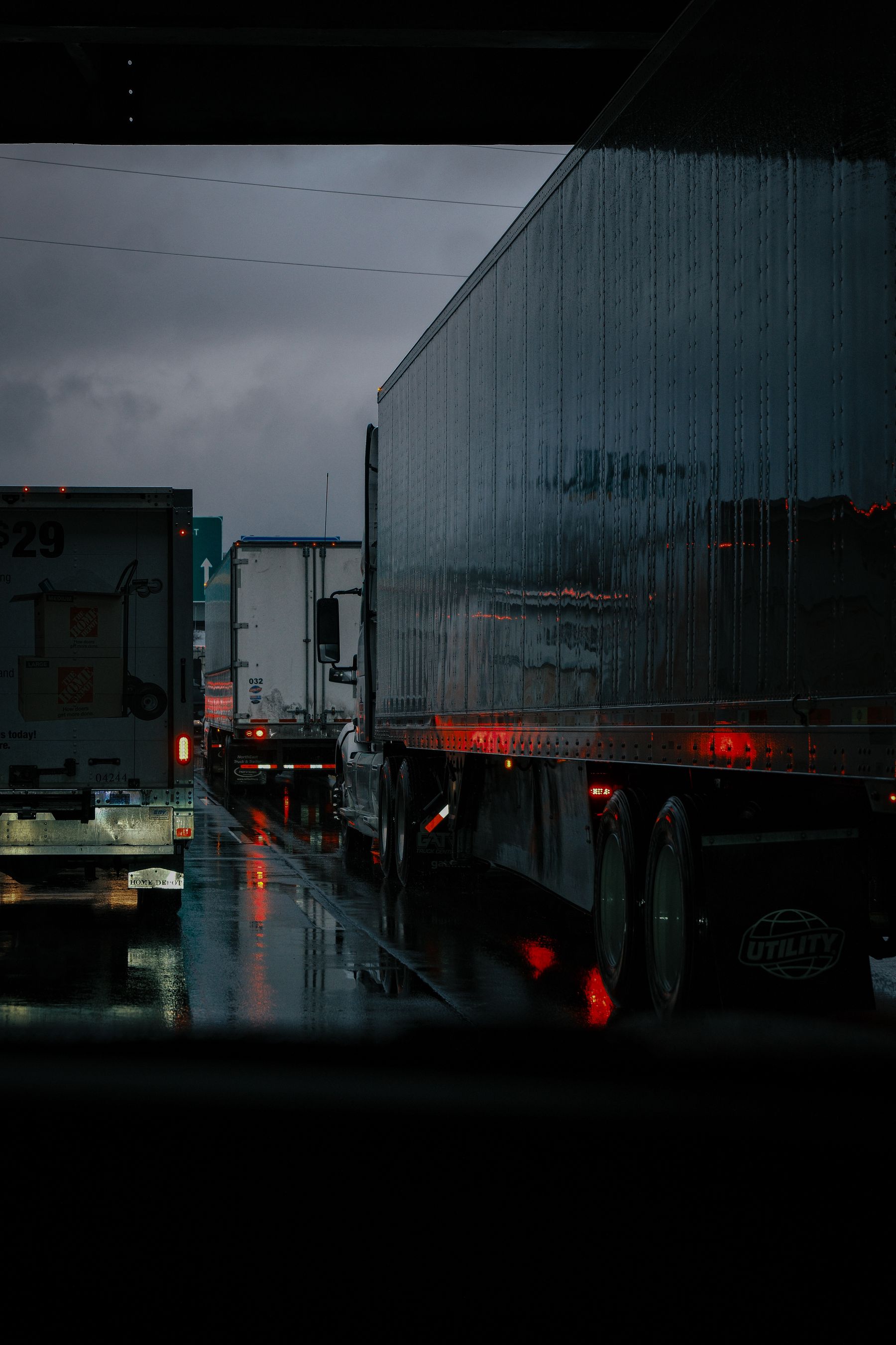 Trailer trucks operating in rainy road conditions