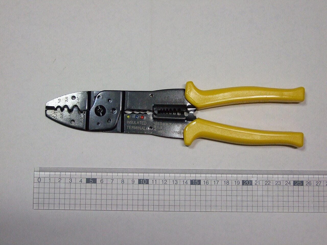 A hand crimp tool illustrates termination work; actual tooling follows the specified contact system.