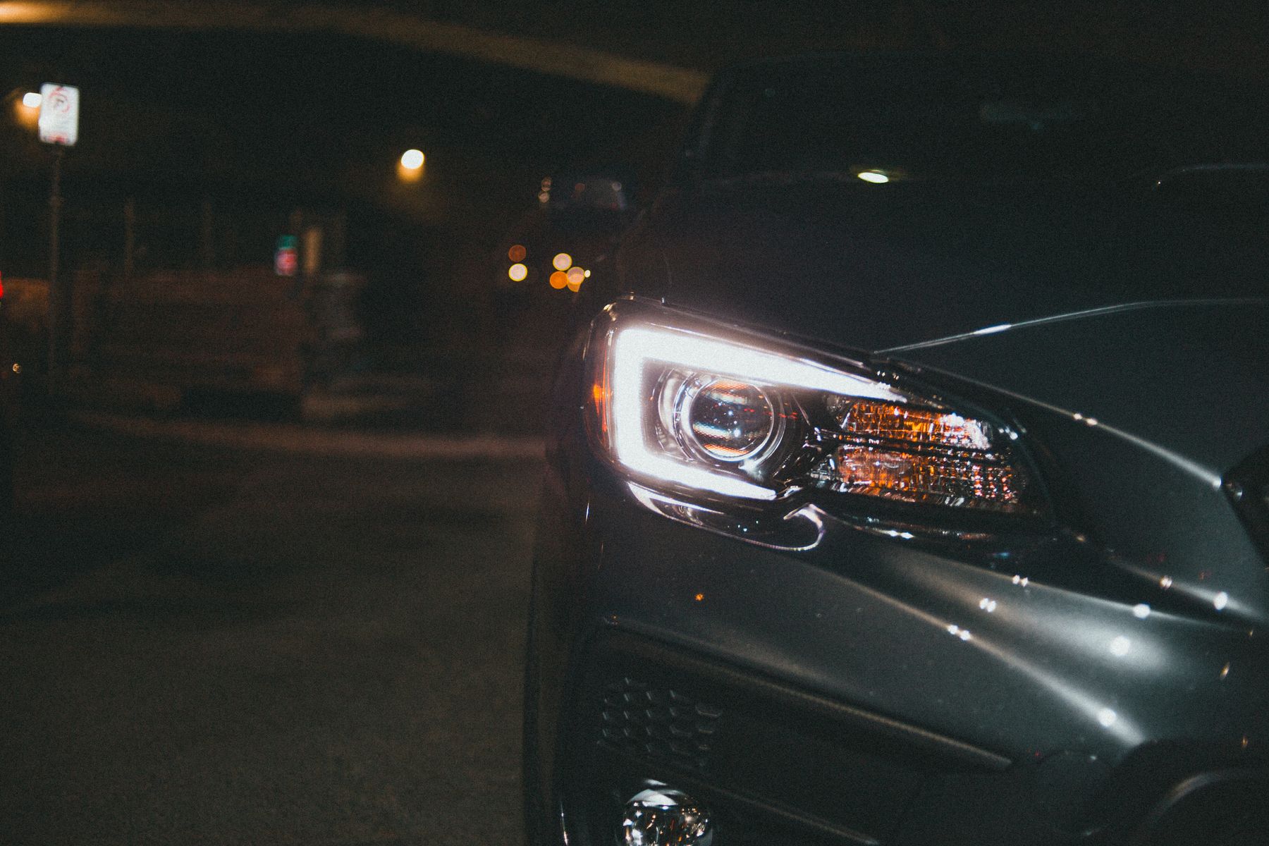 Vehicle headlight illuminated at night