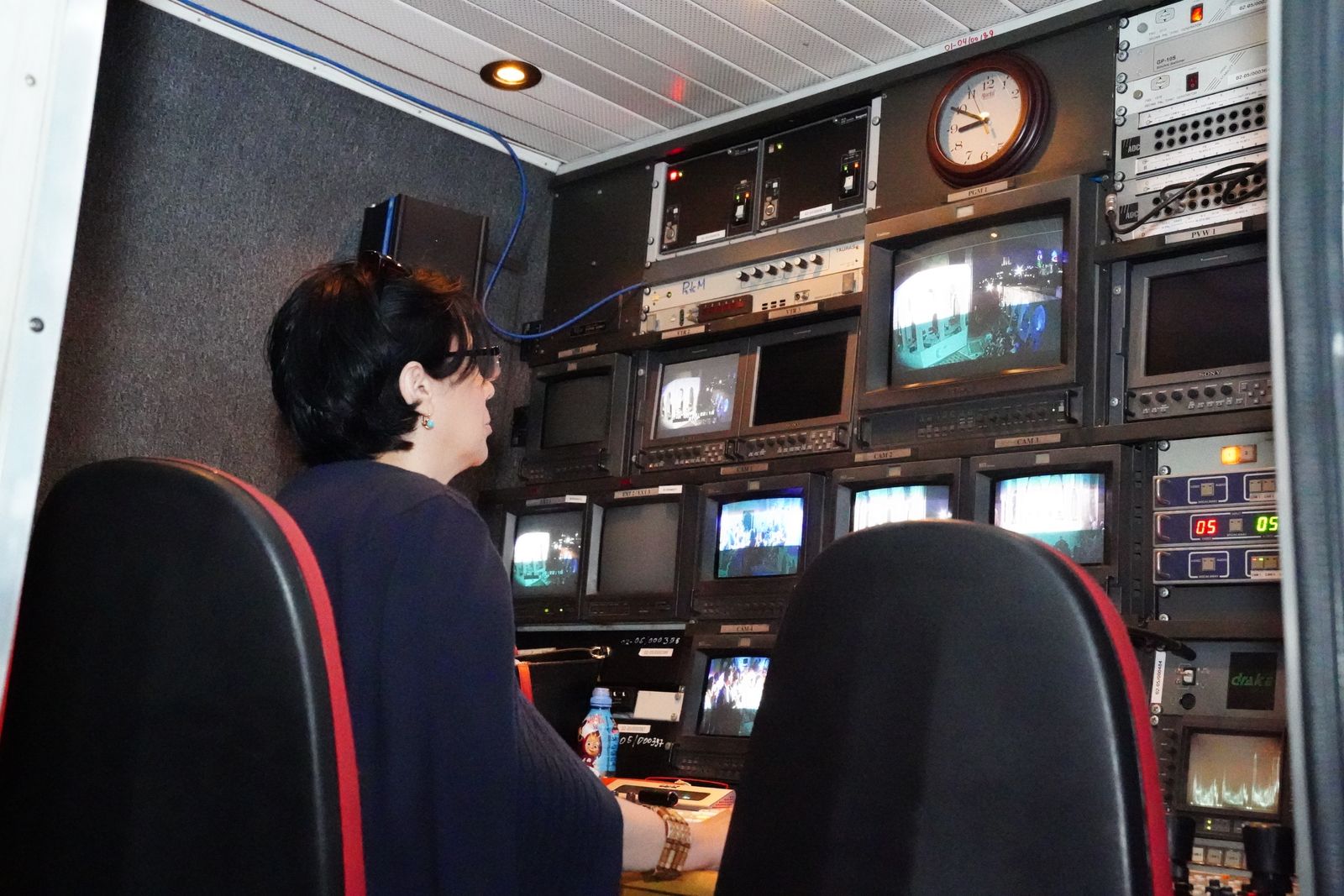 Broadcast control room with staff and multiple screens
